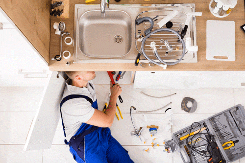 Plumber Working Under a Sink - Get Your Quote