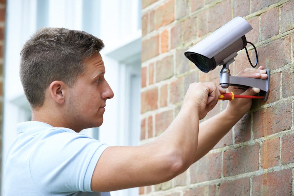 Man installing security camera